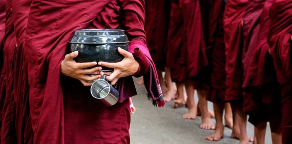 detail-of-buddhist-monks-crowd-and-person-holding-PKCY67V.jpg